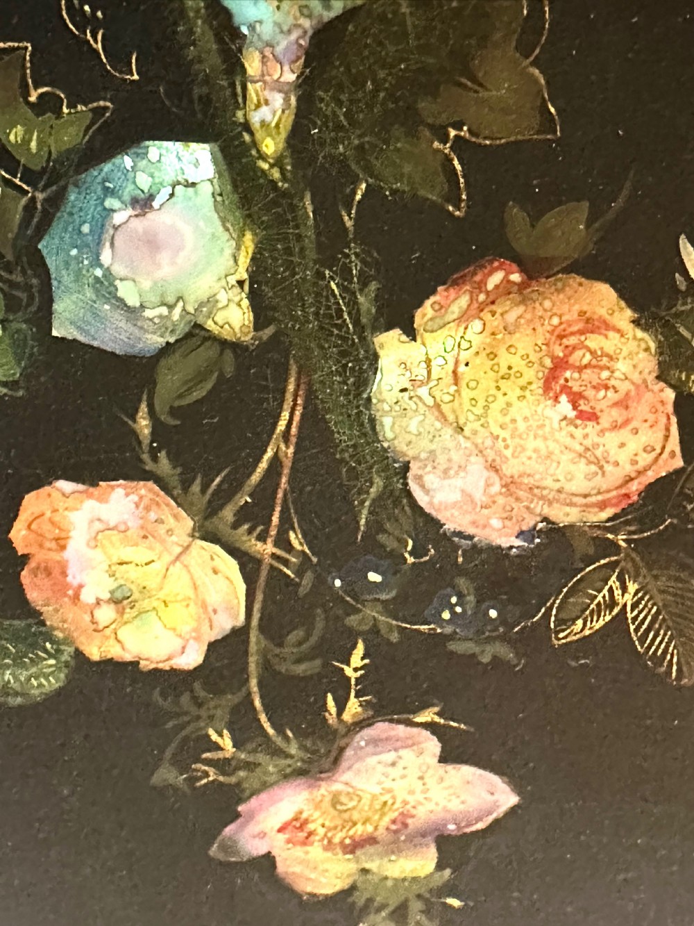 A pair of black Victorian papier-mache face screens with scalloped edges, hand-painted floral motifs inlaid with mother-of-pearl, and turned ebonised handles. View V