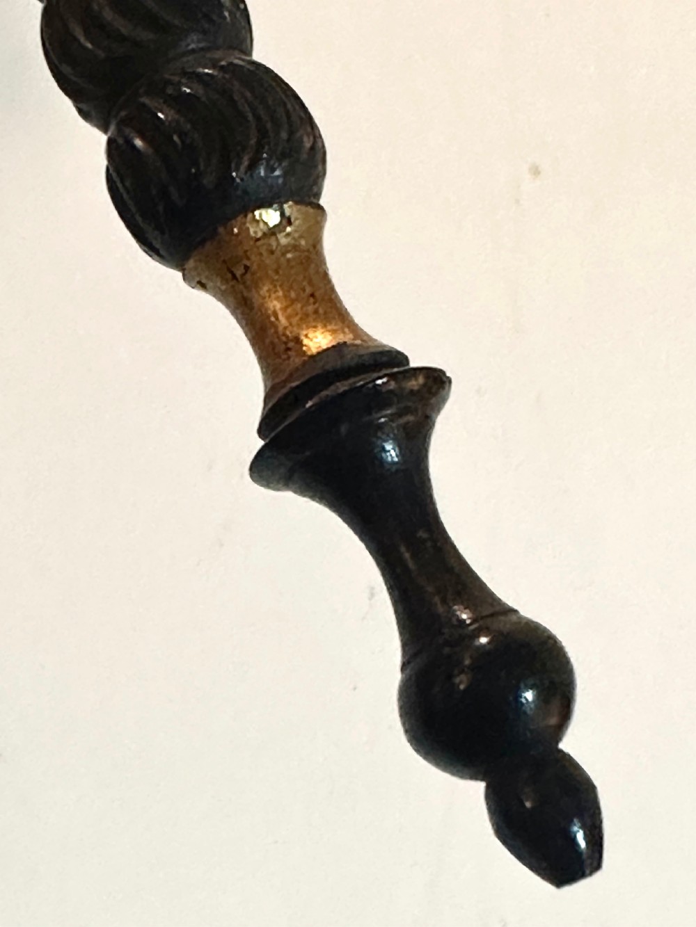 A pair of black Victorian papier-mache face screens with scalloped edges, hand-painted floral motifs inlaid with mother-of-pearl, and turned ebonised handles. View VII