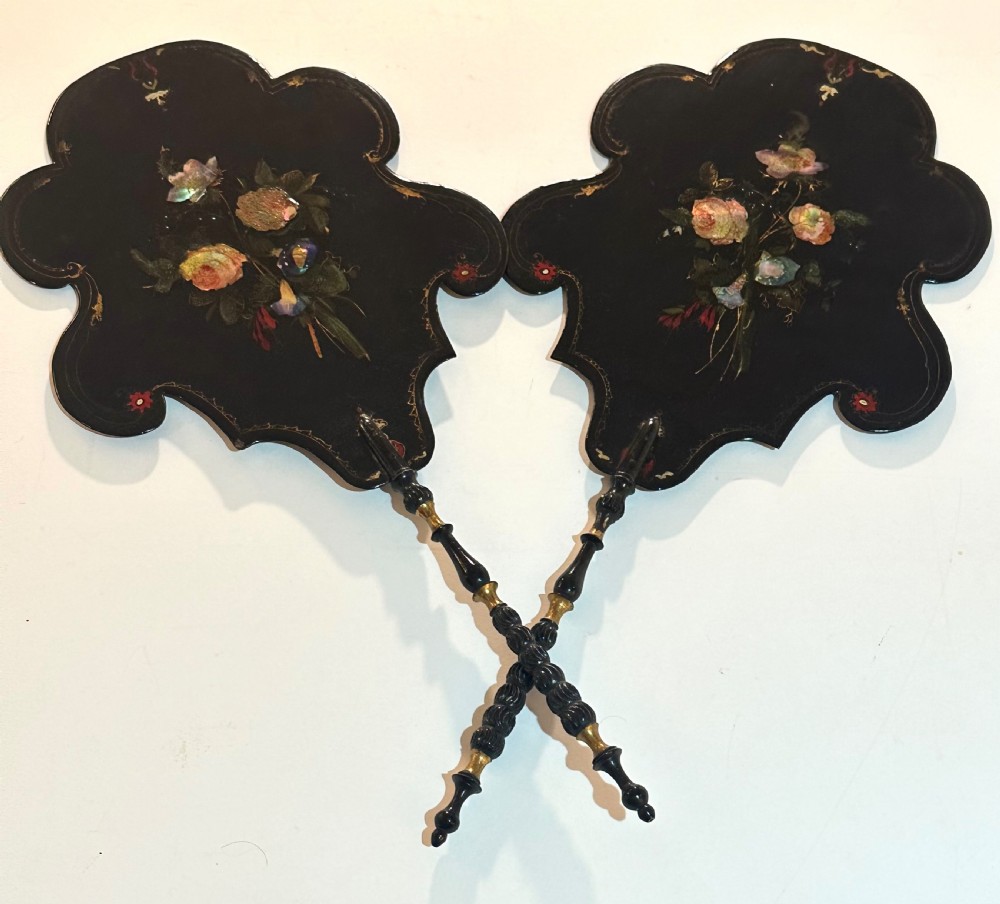 A pair of black Victorian papier-mache face screens with scalloped edges, hand-painted floral motifs inlaid with mother-of-pearl, and turned ebonised handles. View XI
