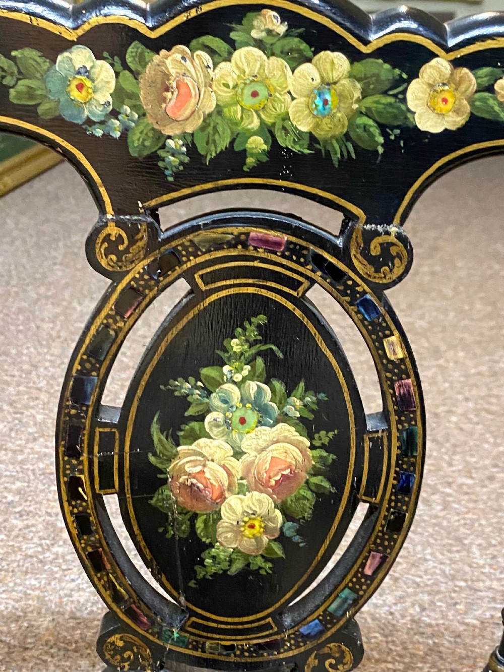 An antique black ebonised wooden bench with hand-painted floral panels, gold accents, turned spindle backrest, and two cane seat panels. View VIII