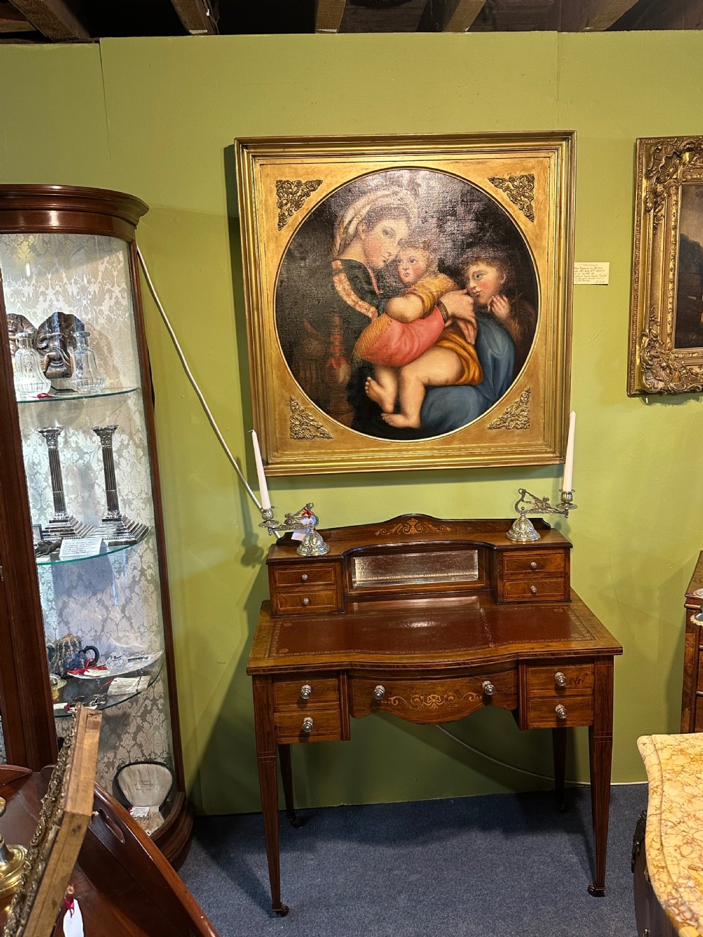 An Edwardian rosewood writing desk with satinwood marquetry, a dark brown leather writing surface, a raised superstructure with small drawers and a mirror, standing on tapered legs with castors. View IX