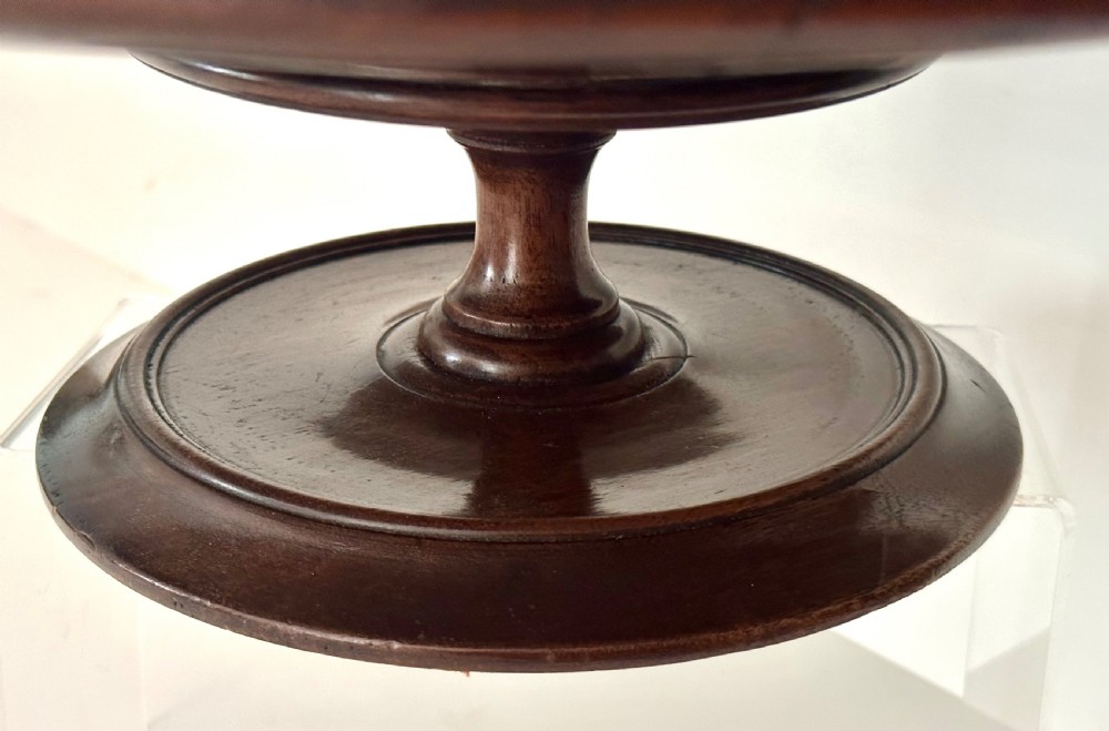 A circular Georgian mahogany Lazy Susan with a raised lip edge set upon a turned pedestal stem and wide circular base. View V
