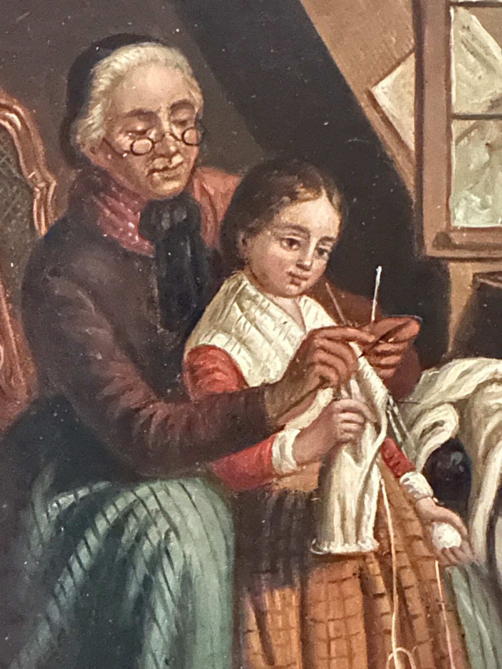 A pair of framed 19th-century oil paintings on tin depicting domestic interior genre scenes, mounted within broad maple veneer frames with gilded inner slips. View X