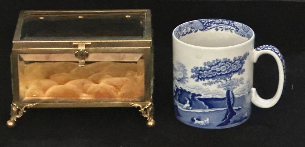 A rectangular French glass trinket box featuring a gilded ormolu frame, bevelled glass panels, decorative cast feet, and a tufted tan velvet cushion inside. View XI