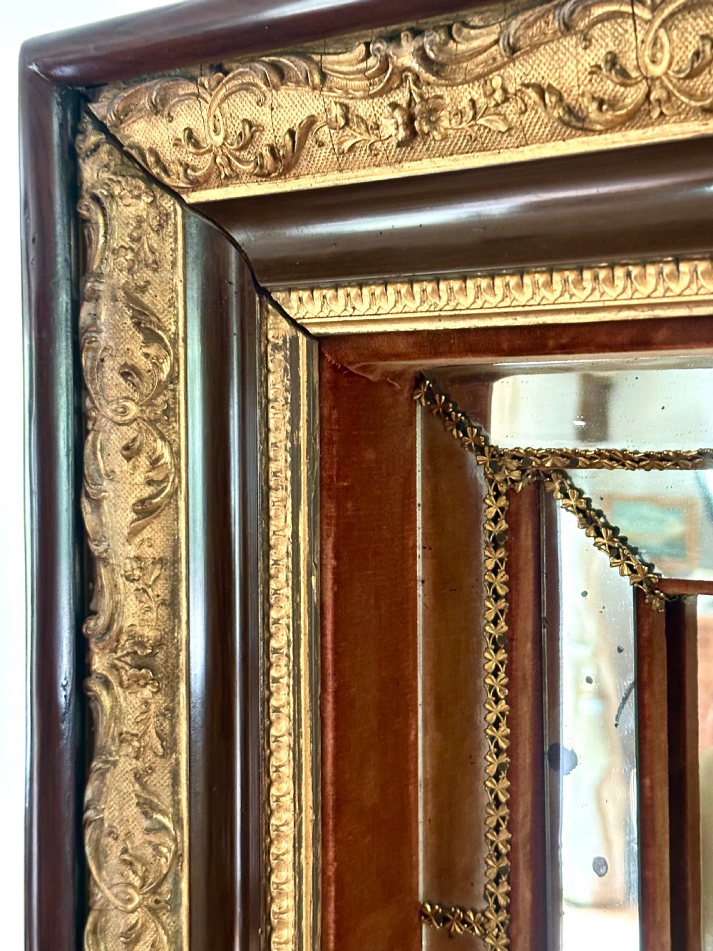A rectangular nineteenth-century Italian wall mirror featuring a moulded dark wood and gilded carved frame surrounding marginal mirrored glass panels. View VII