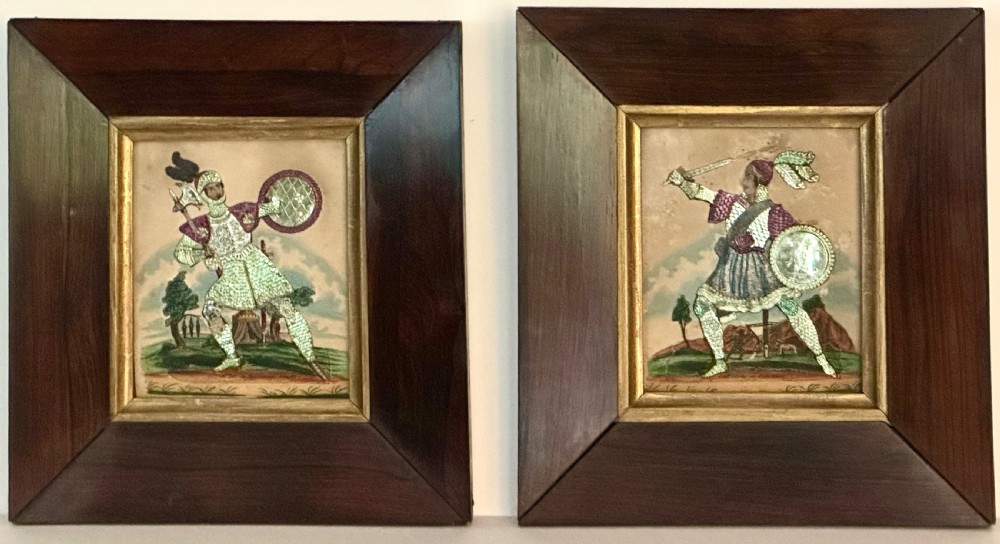 A pair of framed Regency theatrical tinsel pictures depicting armoured figures with weapons set inside dark wood frames with gold slips.