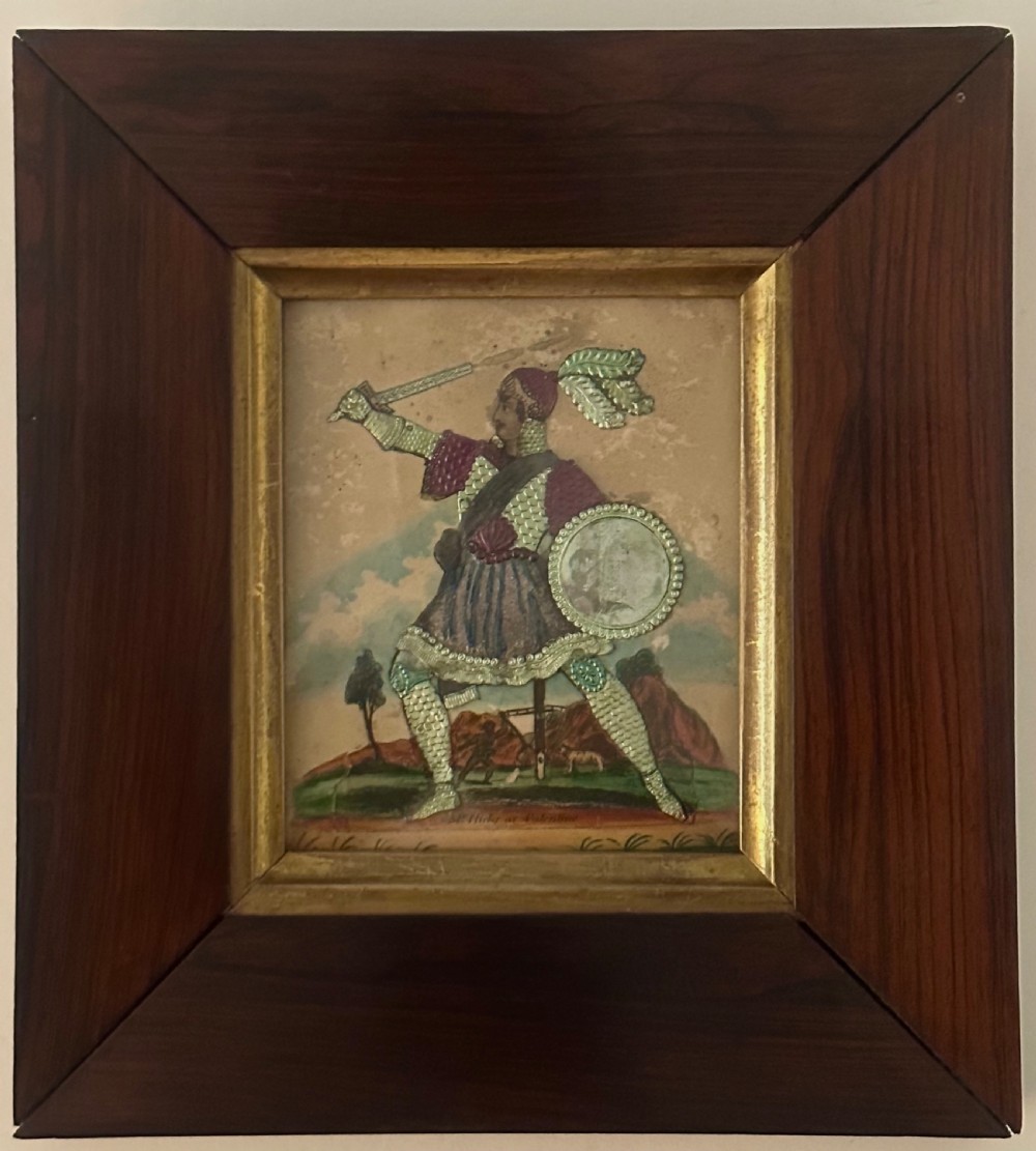 A pair of framed Regency theatrical tinsel pictures depicting armoured figures with weapons set inside dark wood frames with gold slips. View V
