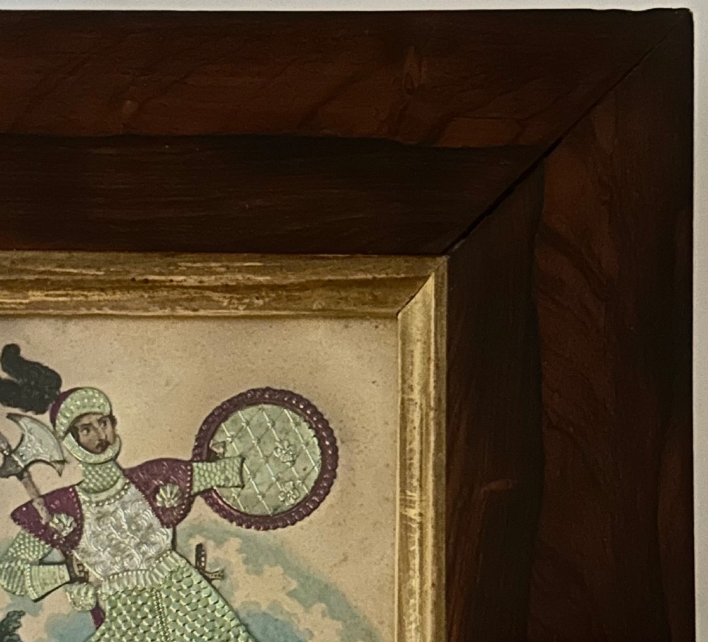 A pair of framed Regency theatrical tinsel pictures depicting armoured figures with weapons set inside dark wood frames with gold slips. View VII