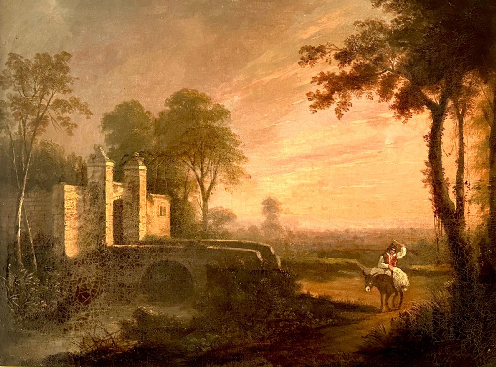 An 18th-century oil painting on canvas depicting a rural landscape with a stone gatehouse, a figure riding a donkey, and a warm sunset sky, set within an ornate carved gold gilt frame. View II