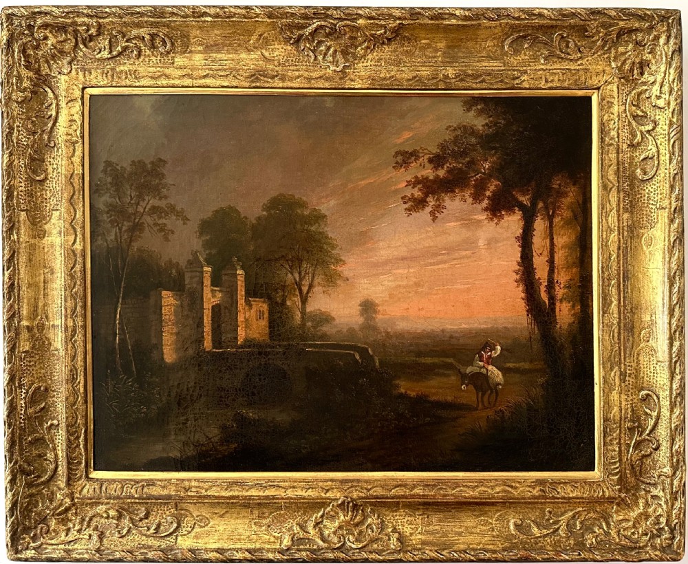 An 18th-century oil painting on canvas depicting a rural landscape with a stone gatehouse, a figure riding a donkey, and a warm sunset sky, set within an ornate carved gold gilt frame.