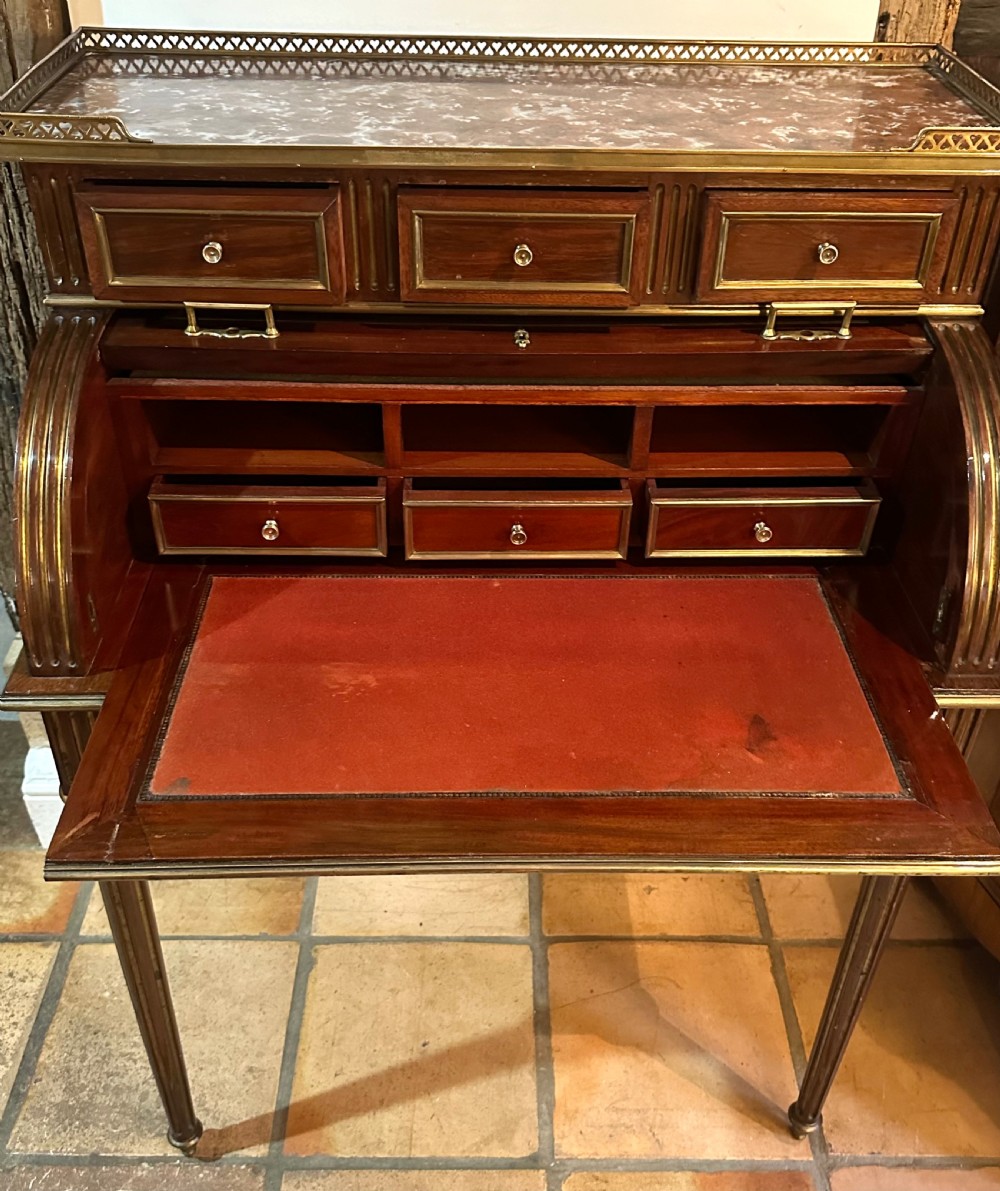 A mahogany French cylinder escritoire featuring a central painted pastoral scene on the roll-top, upper drawer tier, brass mounts, and slender fluted legs. View X