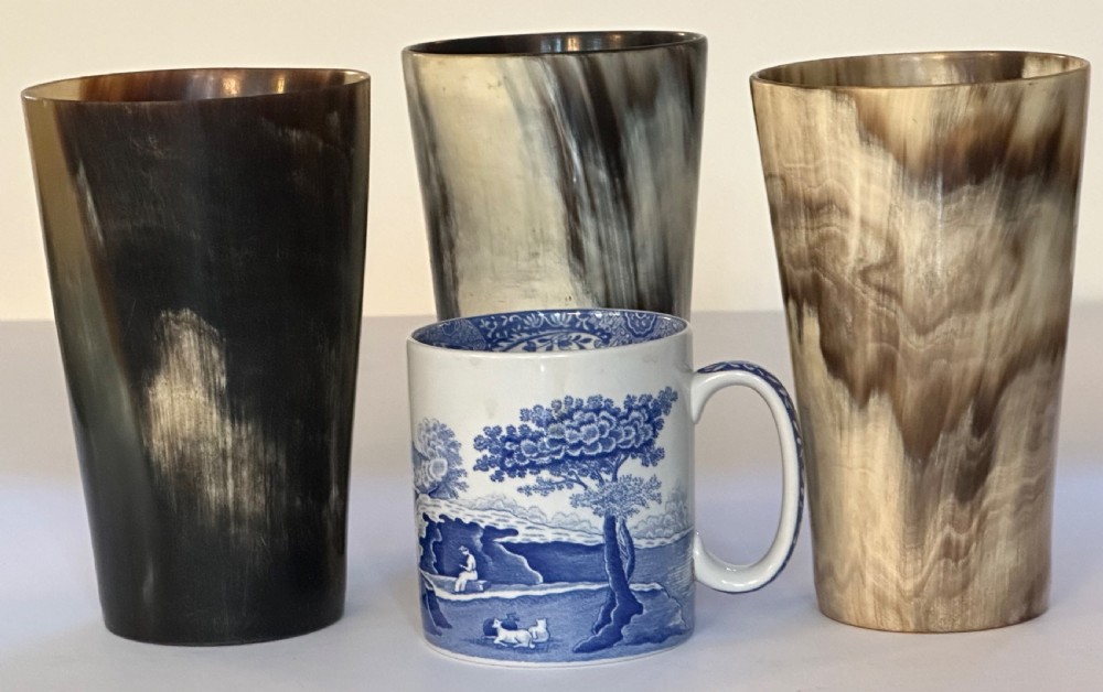 A set of three cylindrical antique drinking beakers made from polished natural horn with variegated cream, amber, and dark brown graining. View III