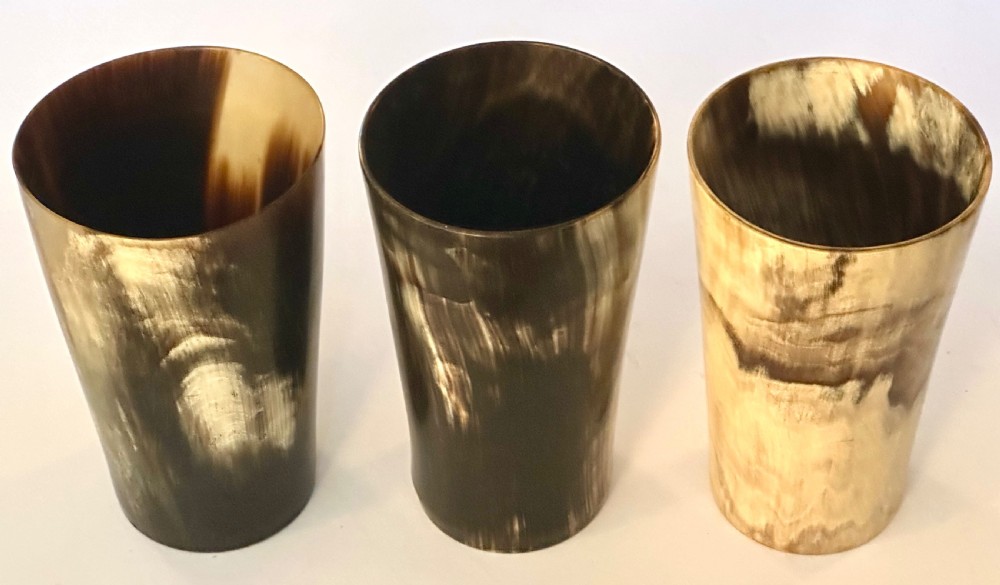 A set of three cylindrical antique drinking beakers made from polished natural horn with variegated cream, amber, and dark brown graining. View IV