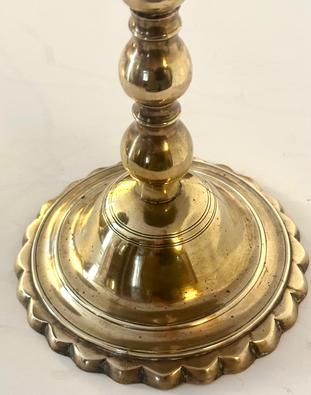 A pair of polished brass pedestal platters featuring turned baluster stems and circular trays on stepped round bases. View III