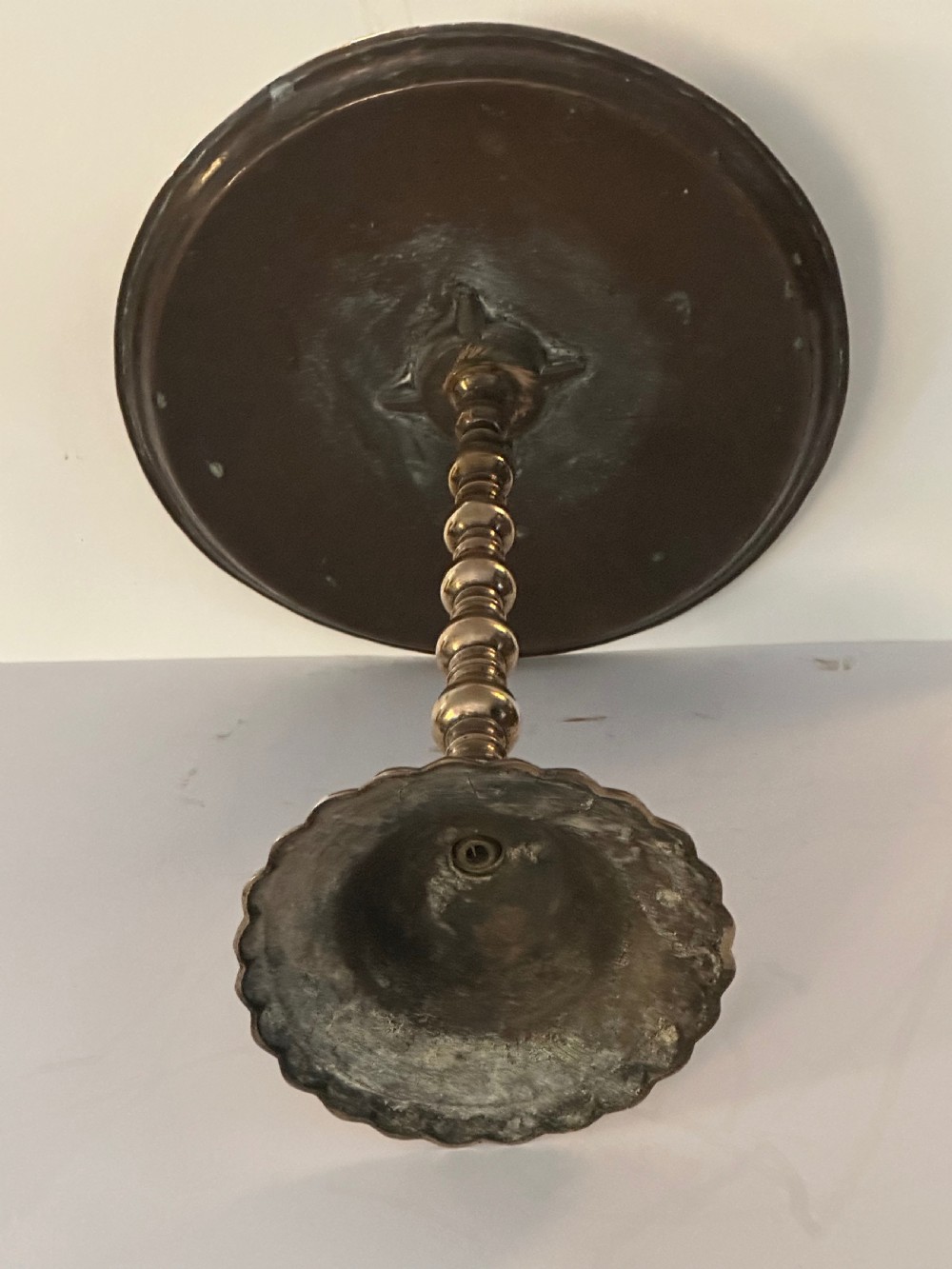A pair of polished brass pedestal platters featuring turned baluster stems and circular trays on stepped round bases. View IV