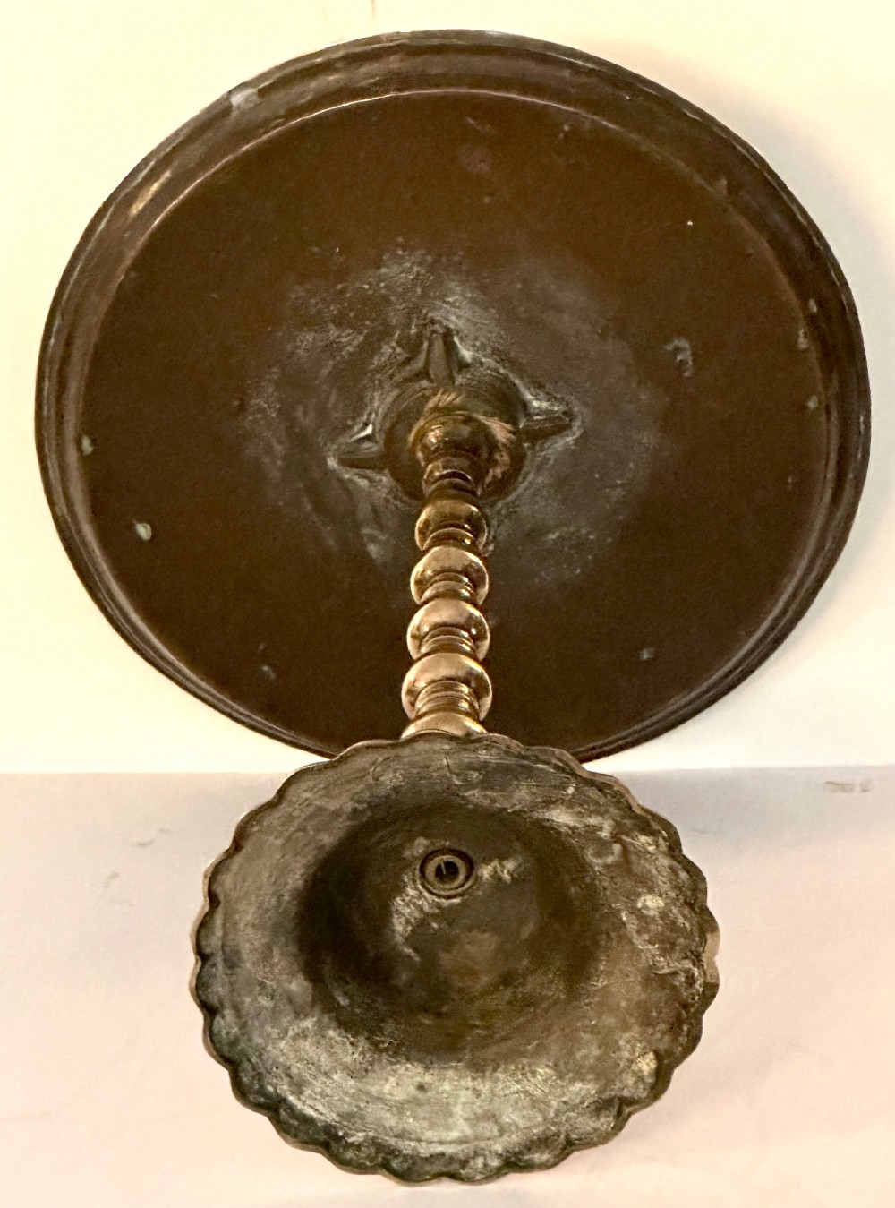 A pair of polished brass pedestal platters featuring turned baluster stems and circular trays on stepped round bases. View V