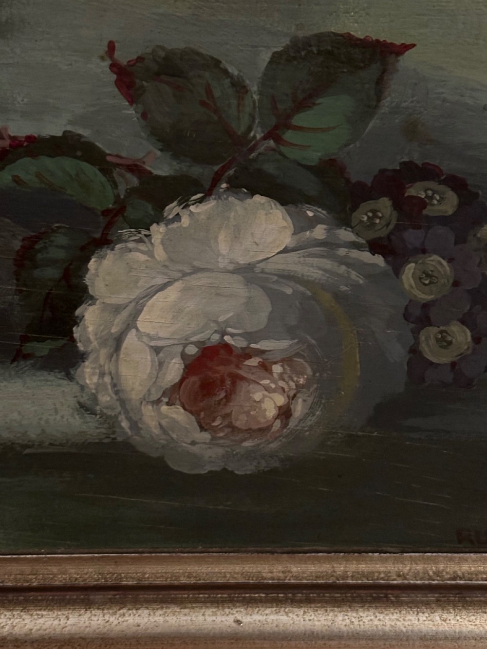 A framed classical floral still life painting depicting a colourful bouquet of flowers inside a stone urn set within an arched architectural niche. View V