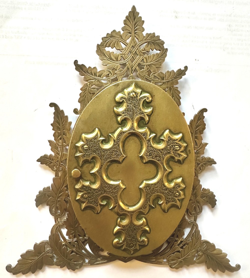 An ornate Victorian brass double picture frame featuring two oval apertures framed by detailed foliate metalwork and an easel stand. View III
