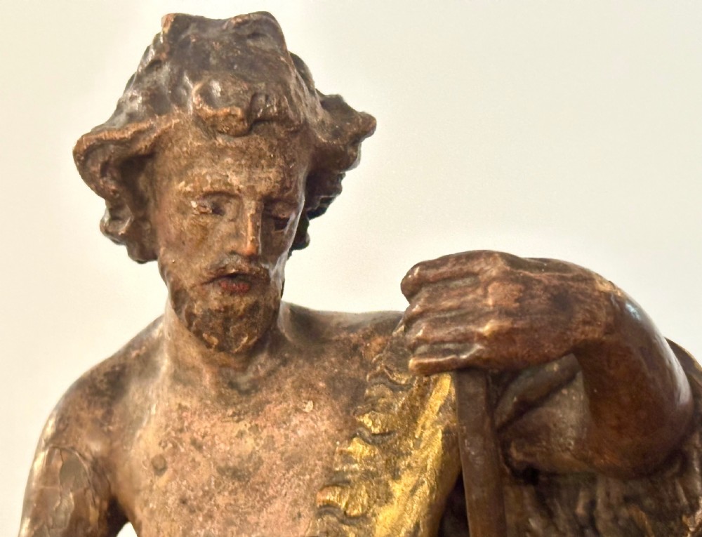 A 17th-century parcel-gilded bronze figure depicting Saint John the Baptist with a staff and lamb, standing on a rectangular wood plinth base. View V