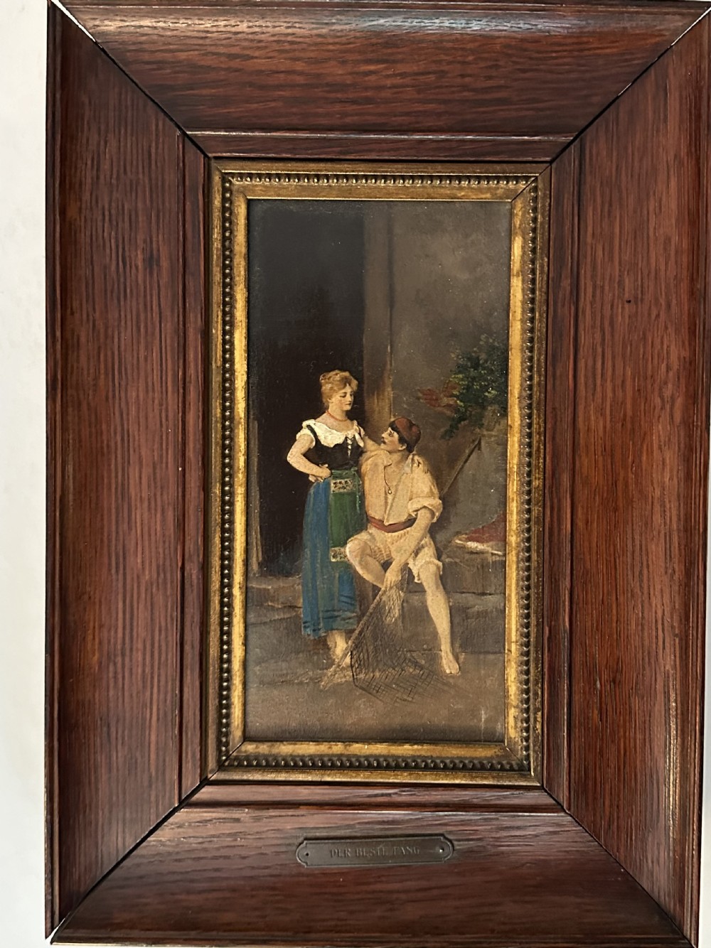A pair of vertical oil paintings on wooden panels depicting rural couples, framed in dark oak moulding with gilt inner slips. View V