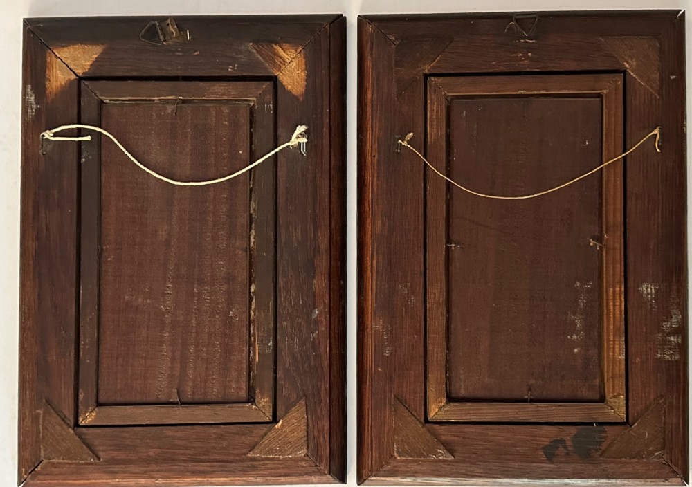 A pair of vertical oil paintings on wooden panels depicting rural couples, framed in dark oak moulding with gilt inner slips. View VIII