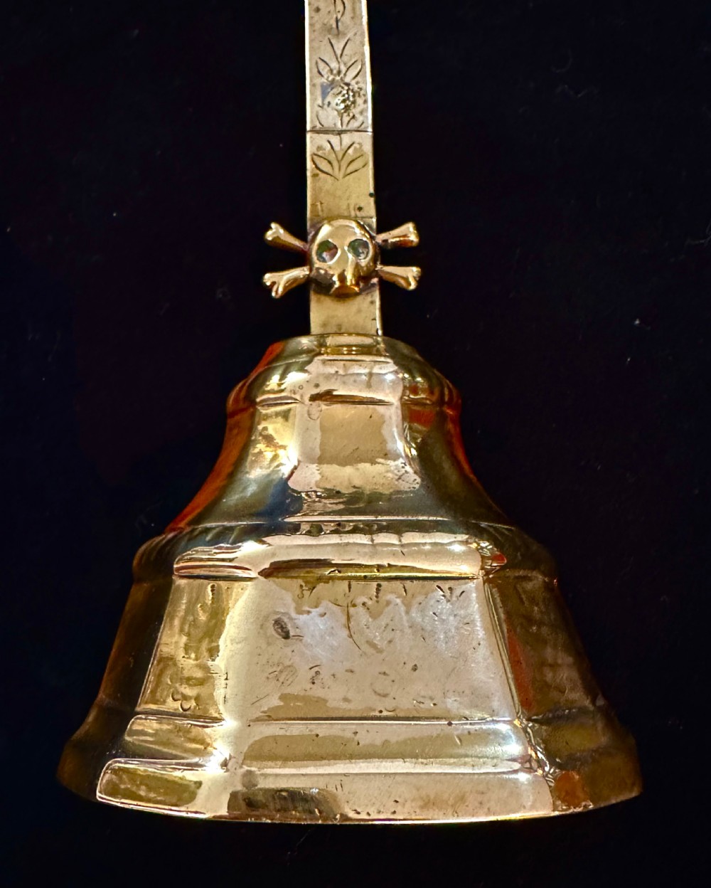 A 19th-century brass standing altar crucifix featuring a cast figure of Christ, fleur-de-lis finials, a skull and crossbones motif, and a hexagonal faceted base. View III