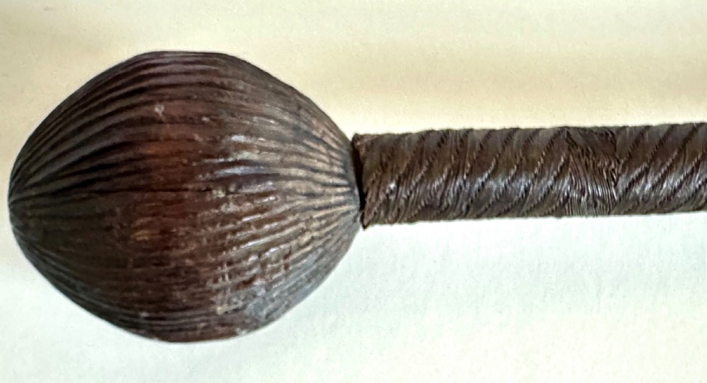 A collection of five traditional Zulu artefacts including a fluted knobkerrie club, a wooden dagger with sheath, and two wire-wrapped spearheads on a plain background. View VII