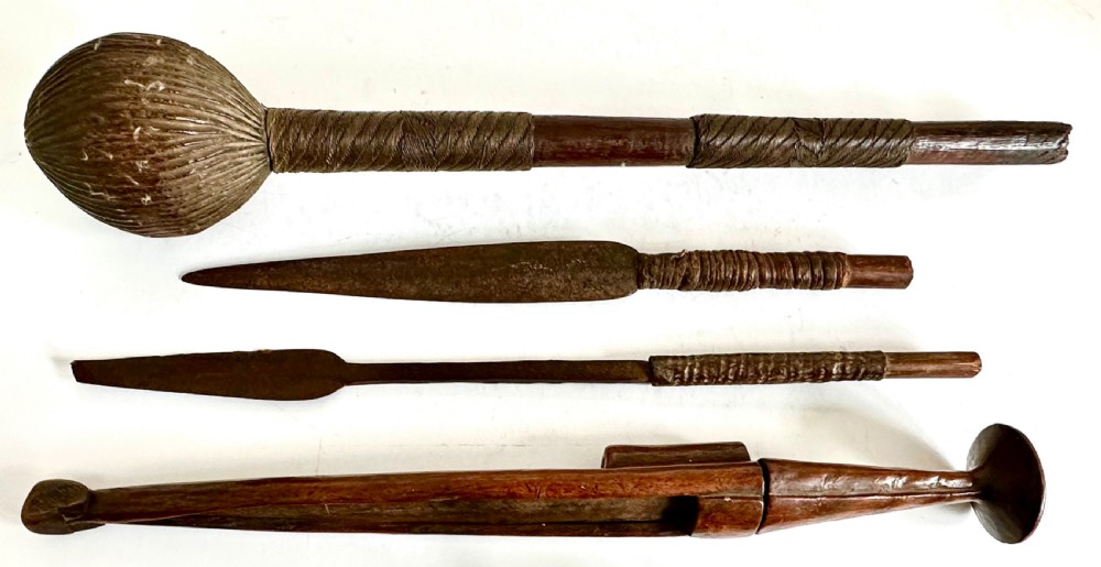 A collection of five traditional Zulu artefacts including a fluted knobkerrie club, a wooden dagger with sheath, and two wire-wrapped spearheads on a plain background. View VIII