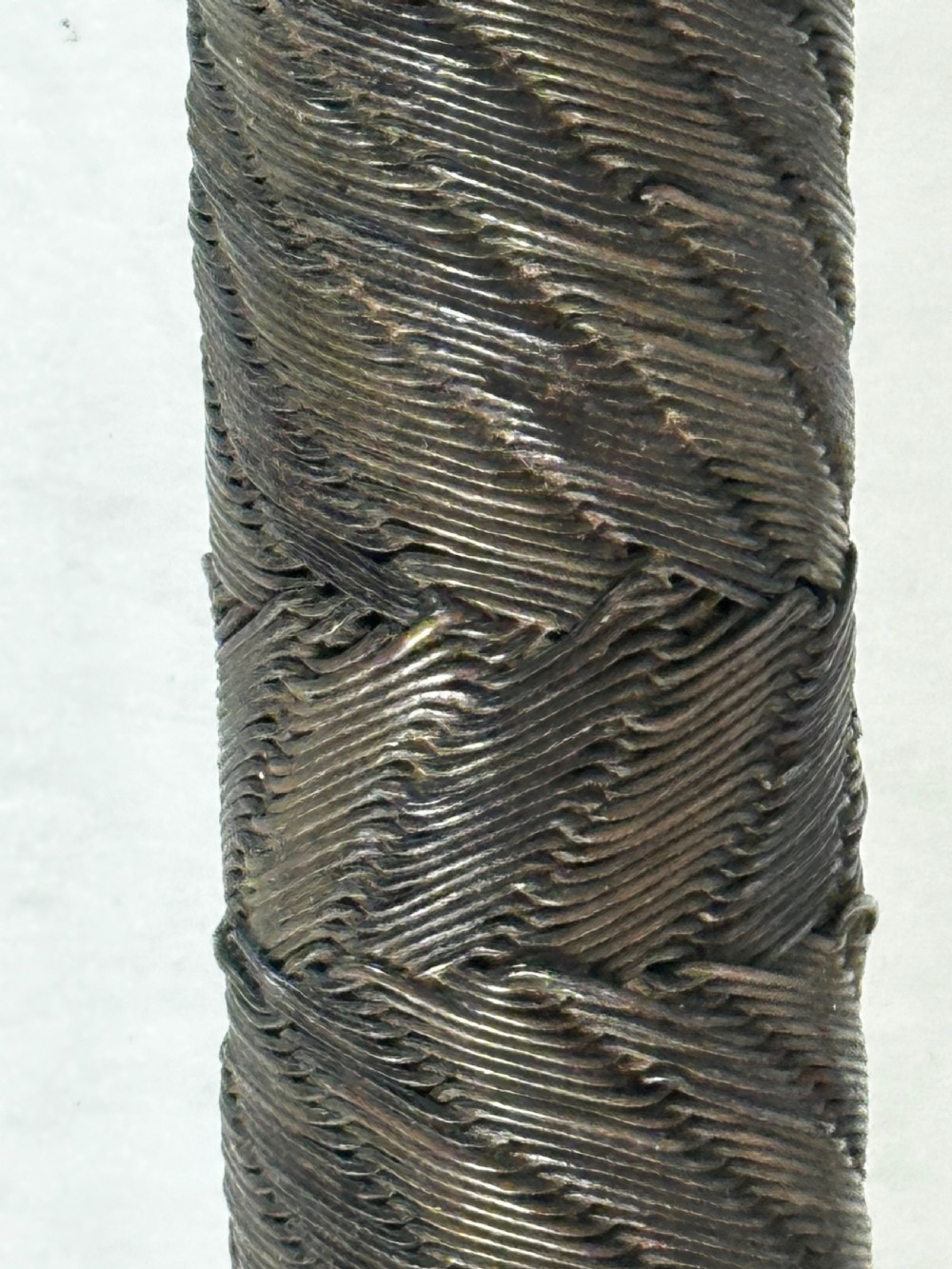 A collection of five traditional Zulu artefacts including a fluted knobkerrie club, a wooden dagger with sheath, and two wire-wrapped spearheads on a plain background. View XI
