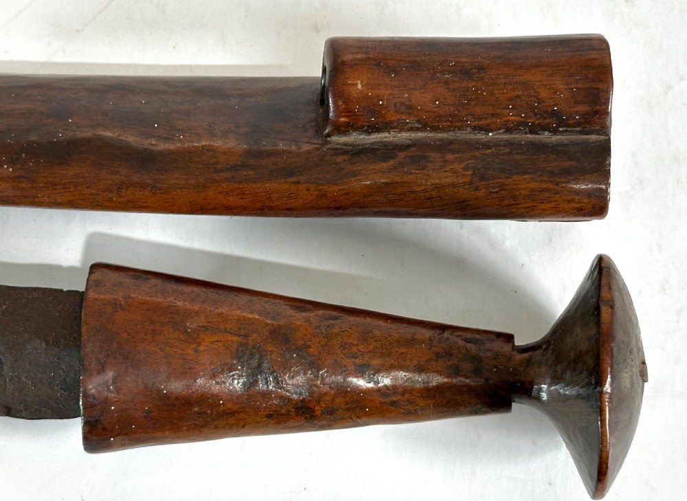 A collection of five traditional Zulu artefacts including a fluted knobkerrie club, a wooden dagger with sheath, and two wire-wrapped spearheads on a plain background. View XIII