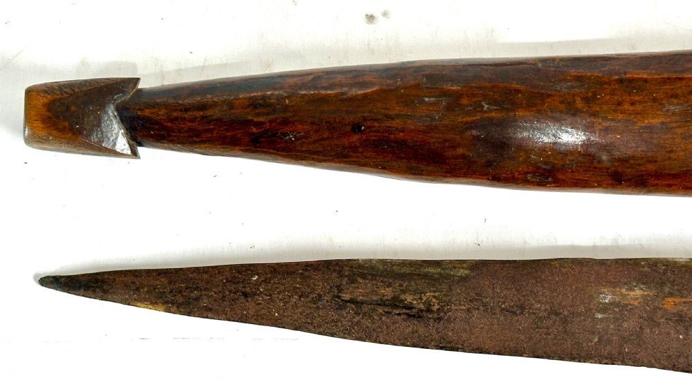 A collection of five traditional Zulu artefacts including a fluted knobkerrie club, a wooden dagger with sheath, and two wire-wrapped spearheads on a plain background. View XIV