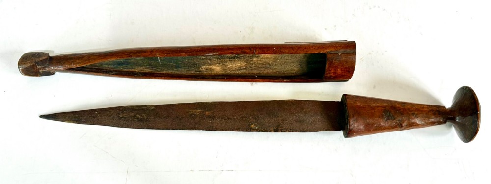 A collection of five traditional Zulu artefacts including a fluted knobkerrie club, a wooden dagger with sheath, and two wire-wrapped spearheads on a plain background. View XV