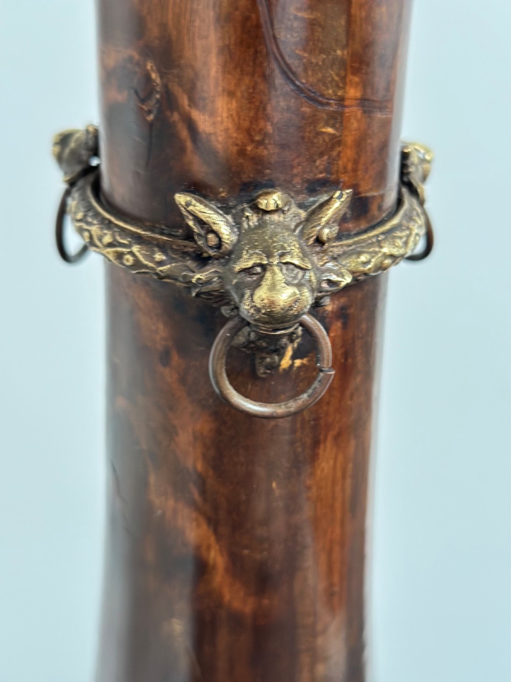 A tall dark hardwood torchere stand featuring a turned central column, brass ormolu mounts, circular top, and a tripod base. View VIII