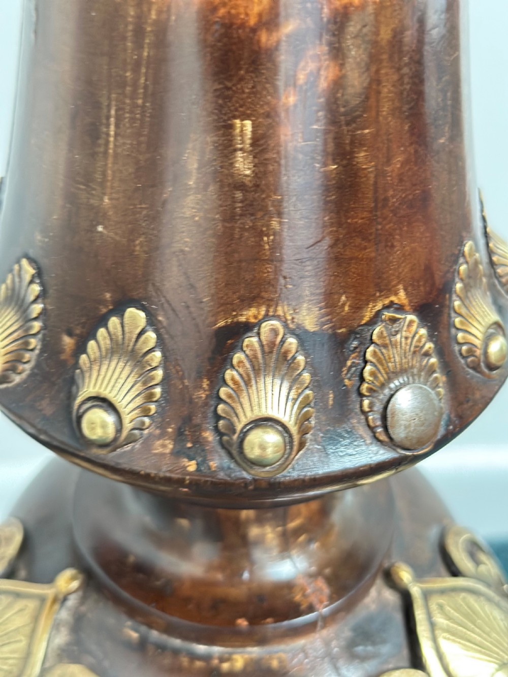 A tall dark hardwood torchere stand featuring a turned central column, brass ormolu mounts, circular top, and a tripod base. View IX