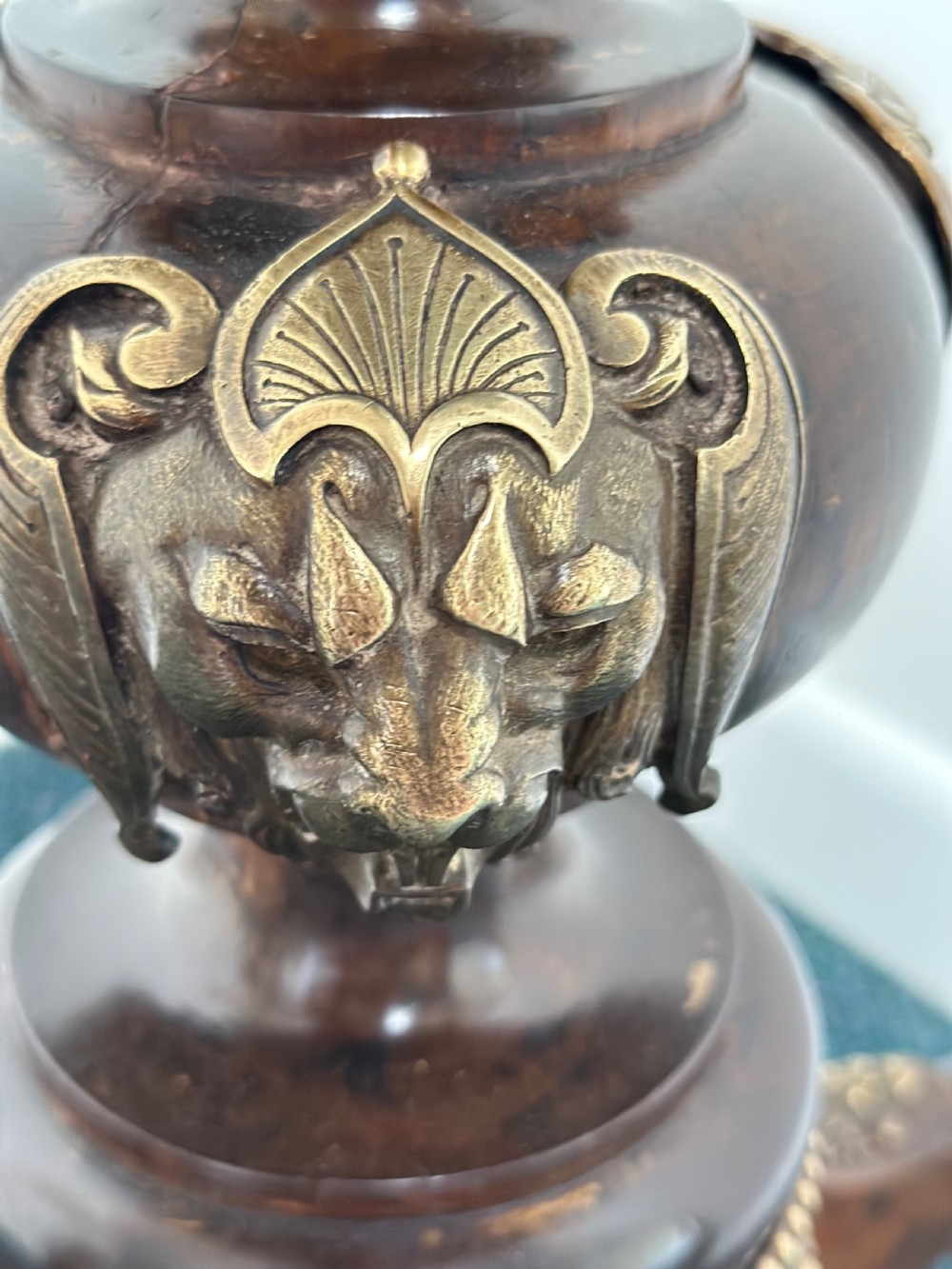 A tall dark hardwood torchere stand featuring a turned central column, brass ormolu mounts, circular top, and a tripod base. View X