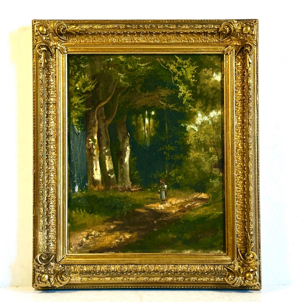 An antique oil painting on canvas depicting a sunlit woodland path with tall green trees and a small figure, set within an ornate gilded frame.