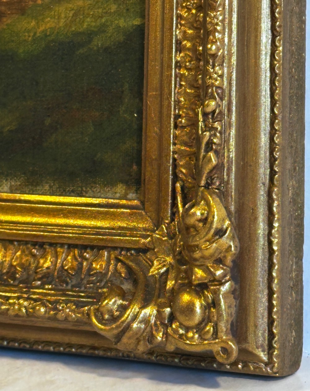 An antique oil painting on canvas depicting a sunlit woodland path with tall green trees and a small figure, set within an ornate gilded frame. View V