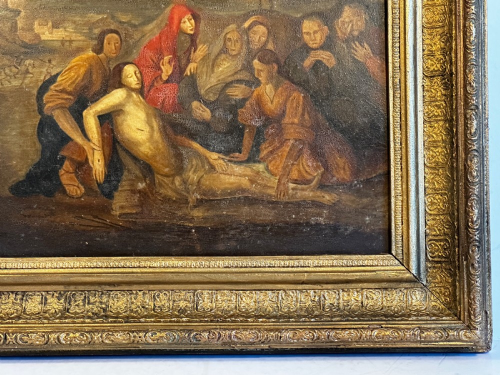 An eighteenth-century Italian oil painting on wood panel depicting the Lamentation of Christ, housed in an ornate carved and gilded frame. View V