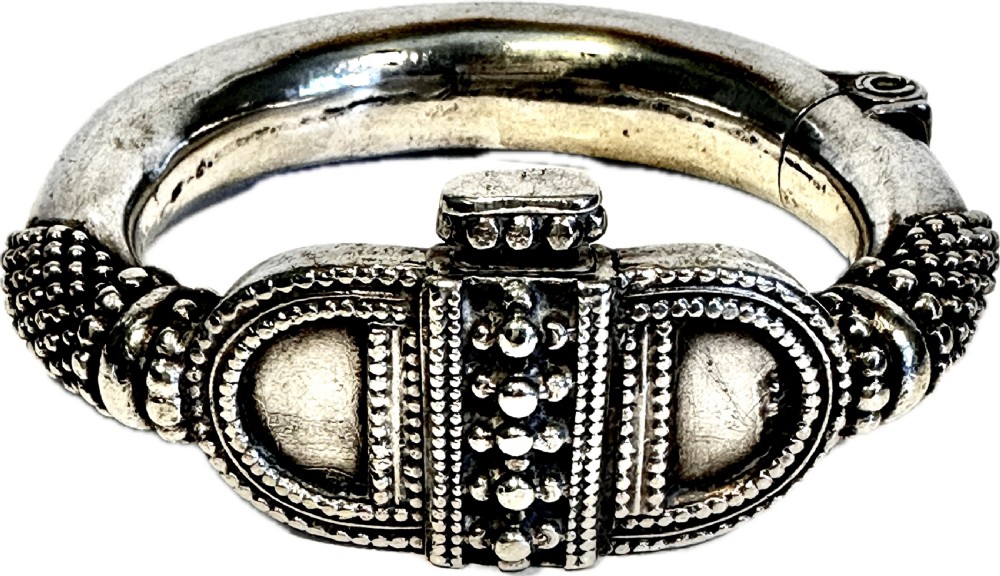 A heavy solid silver Rajasthani bracelet featuring intricate granulation, beaded details, and a central decorative clasp mechanism. View VII
