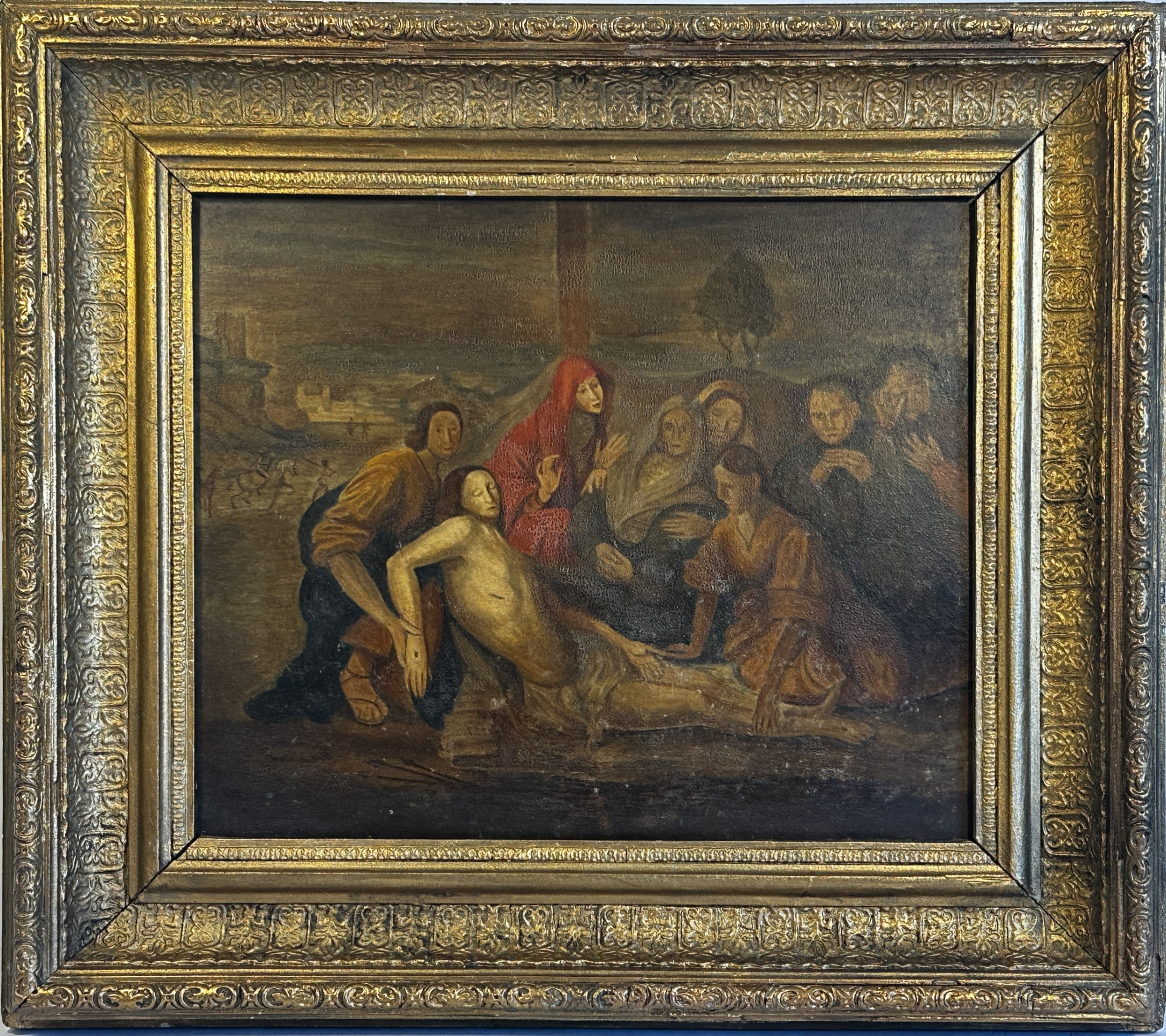 An eighteenth-century Italian oil painting on wood panel depicting the Lamentation of Christ, housed in an ornate carved and gilded frame.