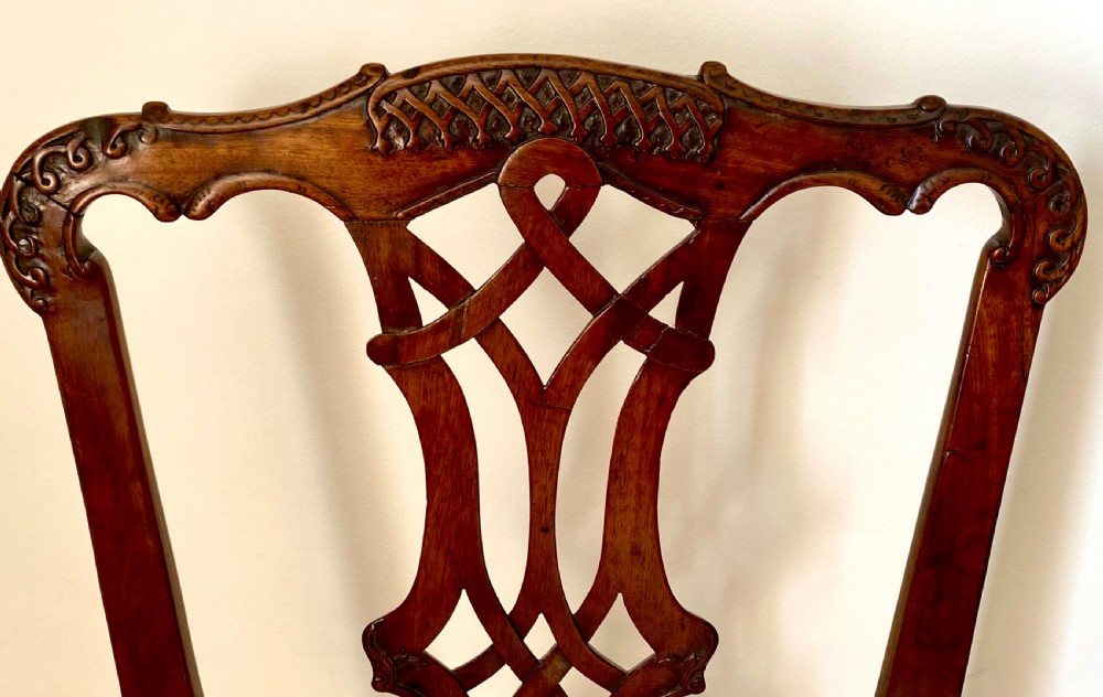 A dark walnut Georgian side chair featuring an intricately carved ribbon-back splat and a gold and red striped upholstered seat. View V