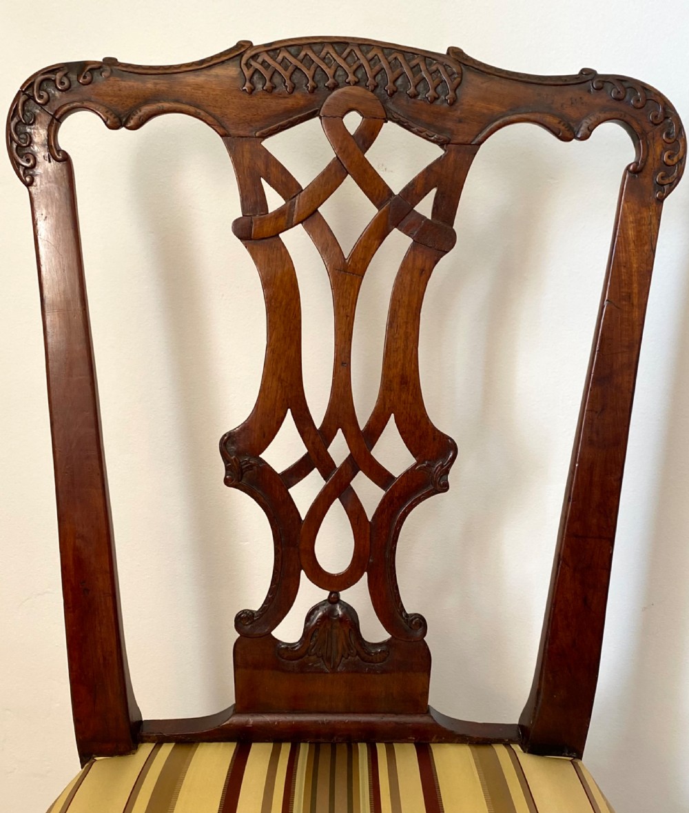 A dark walnut Georgian side chair featuring an intricately carved ribbon-back splat and a gold and red striped upholstered seat. View VI