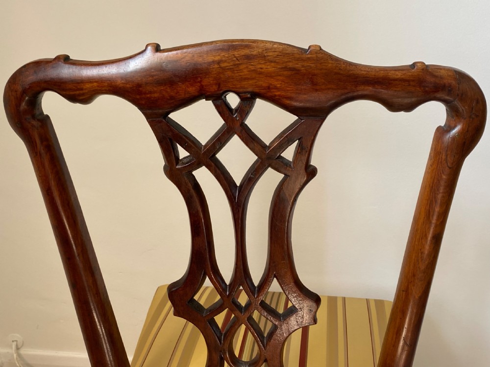 A dark walnut Georgian side chair featuring an intricately carved ribbon-back splat and a gold and red striped upholstered seat. View VII