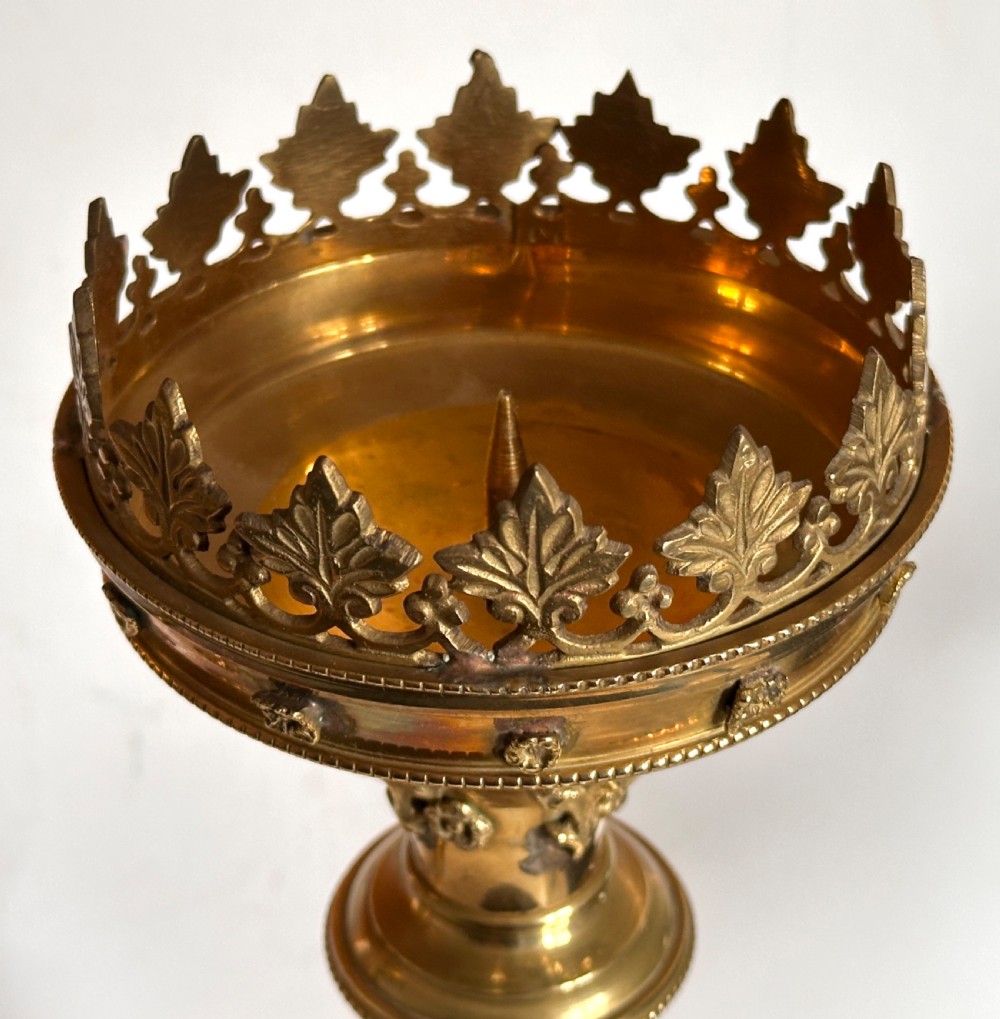 A pair of polished brass ecclesiastical candlesticks featuring pierced coronet galleries, knopped stems, and broad circular bases. View III