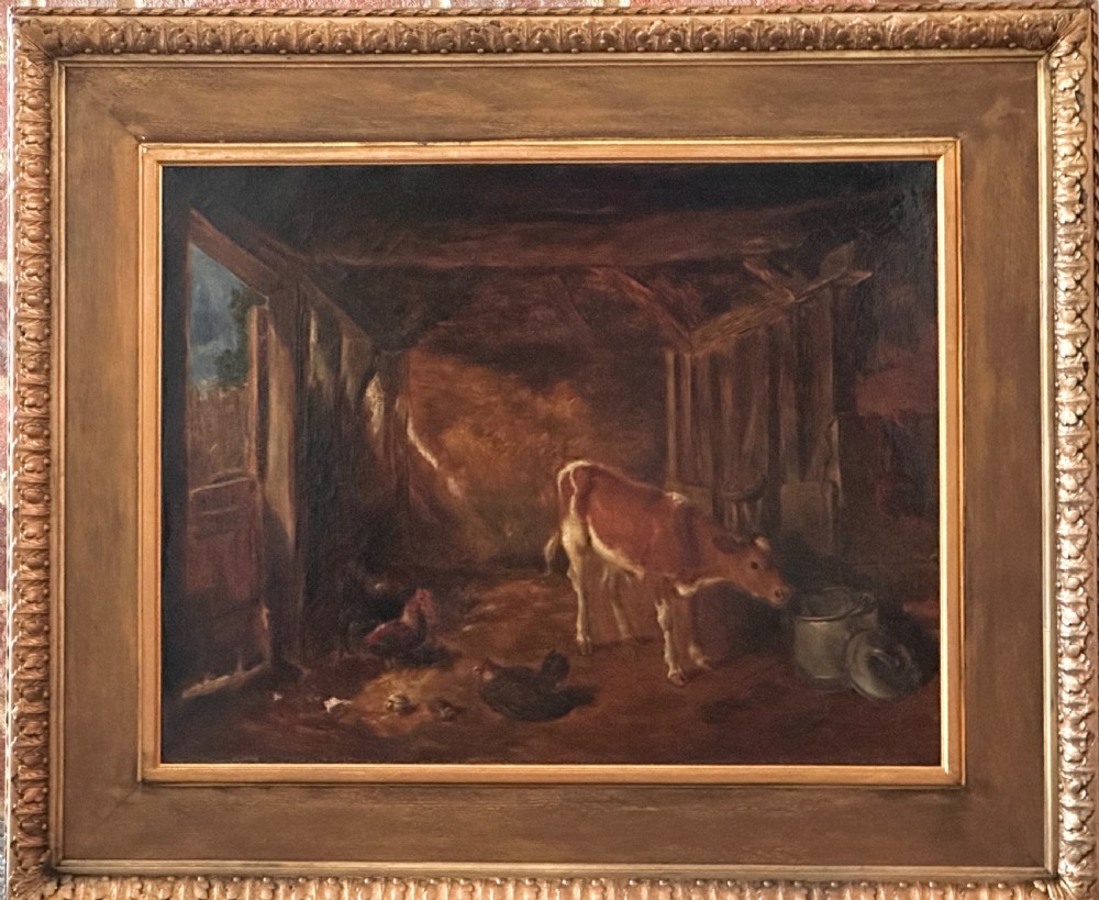 An oil painting on canvas depicting a young calf standing beside a milk container inside a timber barn with chickens on the floor, framed in a wide gilded wood frame.