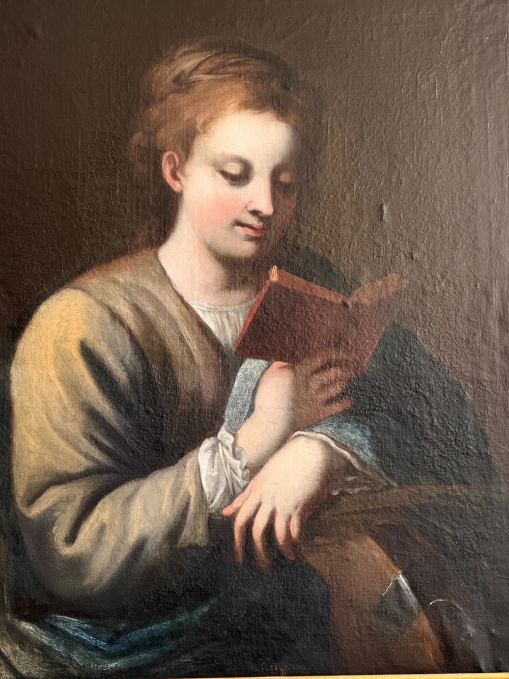 An 18th-century Italian oil painting on canvas depicting Saint Catherine reading a book, set within an ornate gilded carved frame. View III