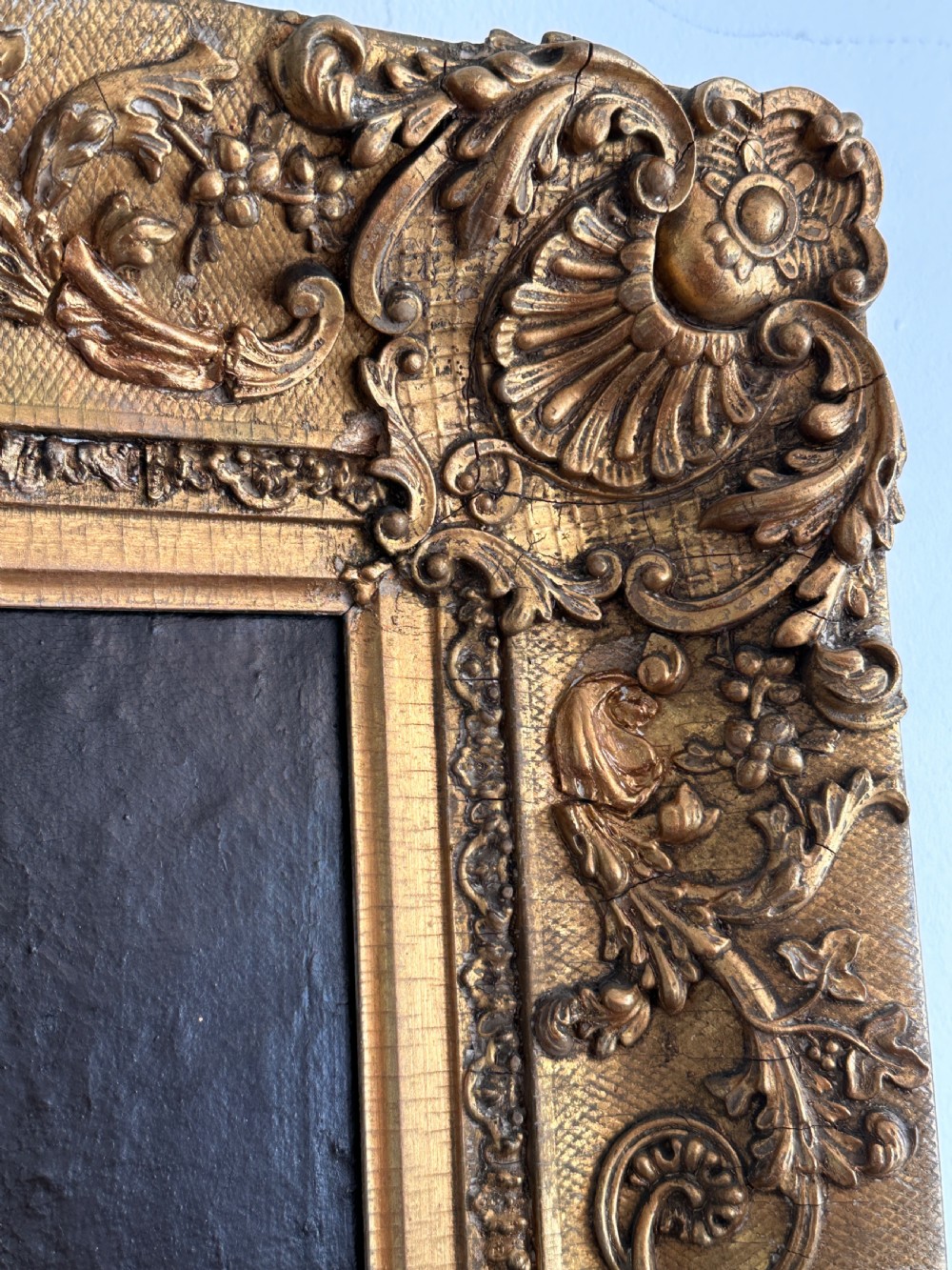 An 18th-century Italian oil painting on canvas depicting Saint Catherine reading a book, set within an ornate gilded carved frame. View V