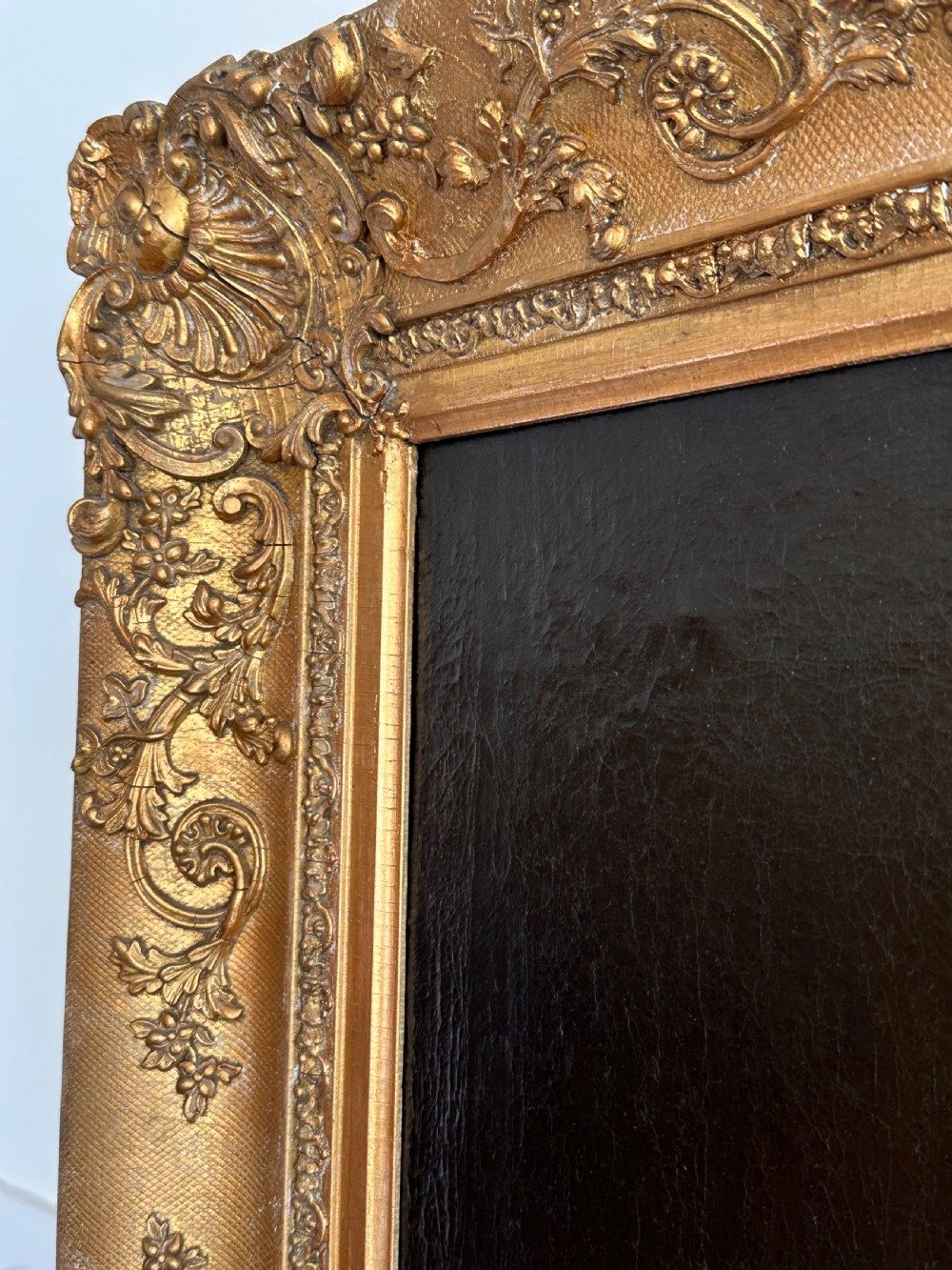 An 18th-century Italian oil painting on canvas depicting Saint Catherine reading a book, set within an ornate gilded carved frame. View VI