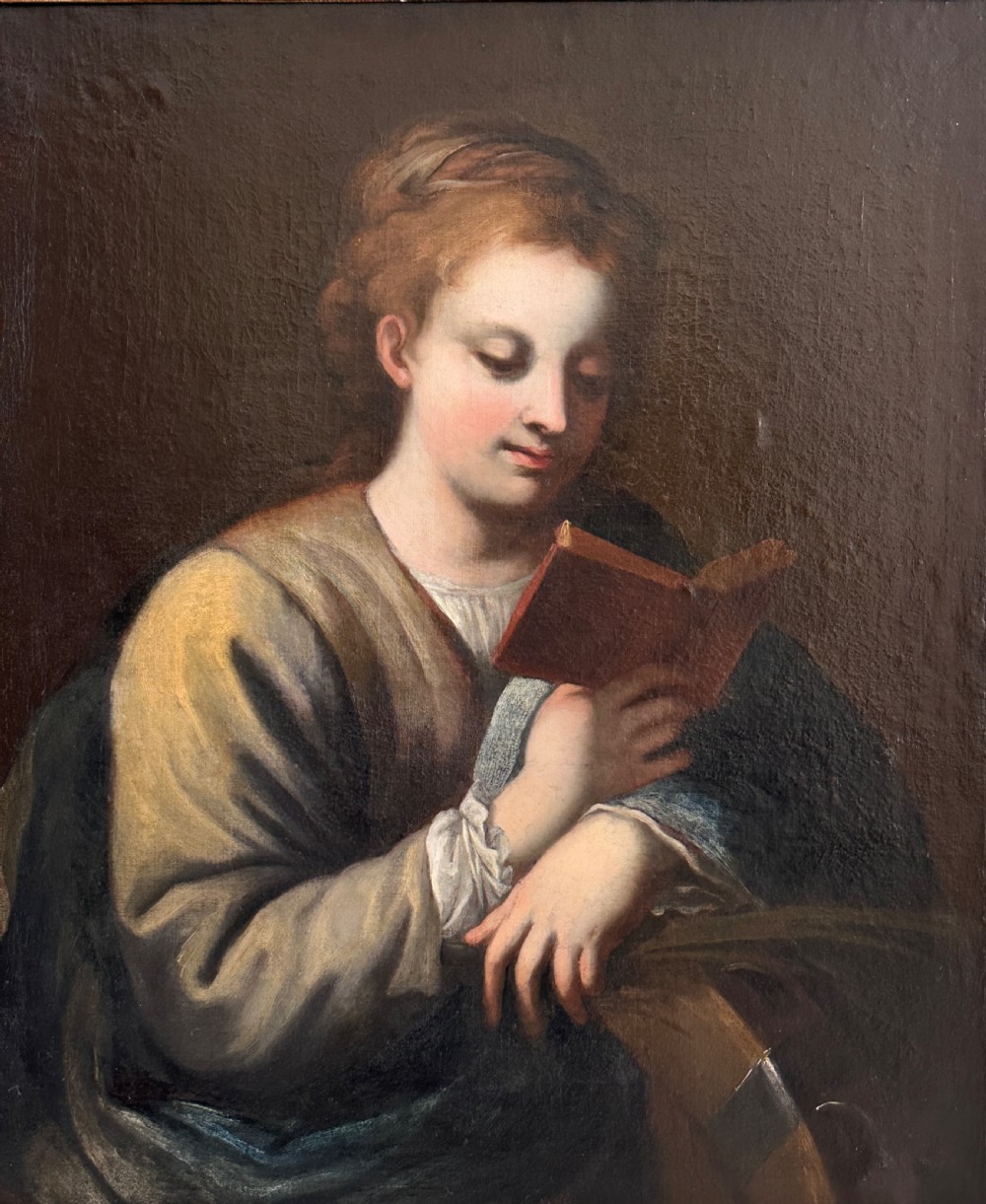 An 18th-century Italian oil painting on canvas depicting Saint Catherine reading a book, set within an ornate gilded carved frame. View VIII