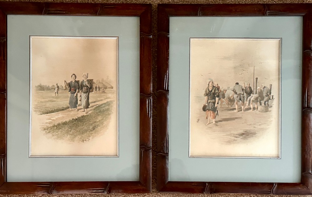 A pair of framed Japanese watercolour paintings depicting figures in traditional clothing set within dark faux-bamboo wooden frames and pale blue mounts.